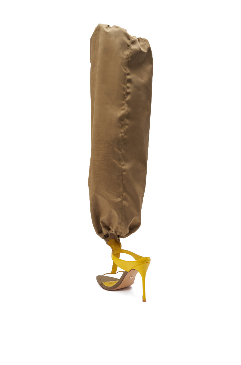 The AKIRA GOLD ZIDANE Olive Canvas Slouchy Stiletto Sandal features a tan, full-length, puffy canvas cover from ankle to above the knee, creating a bold streetwear look inspired by thigh-high boots. 9