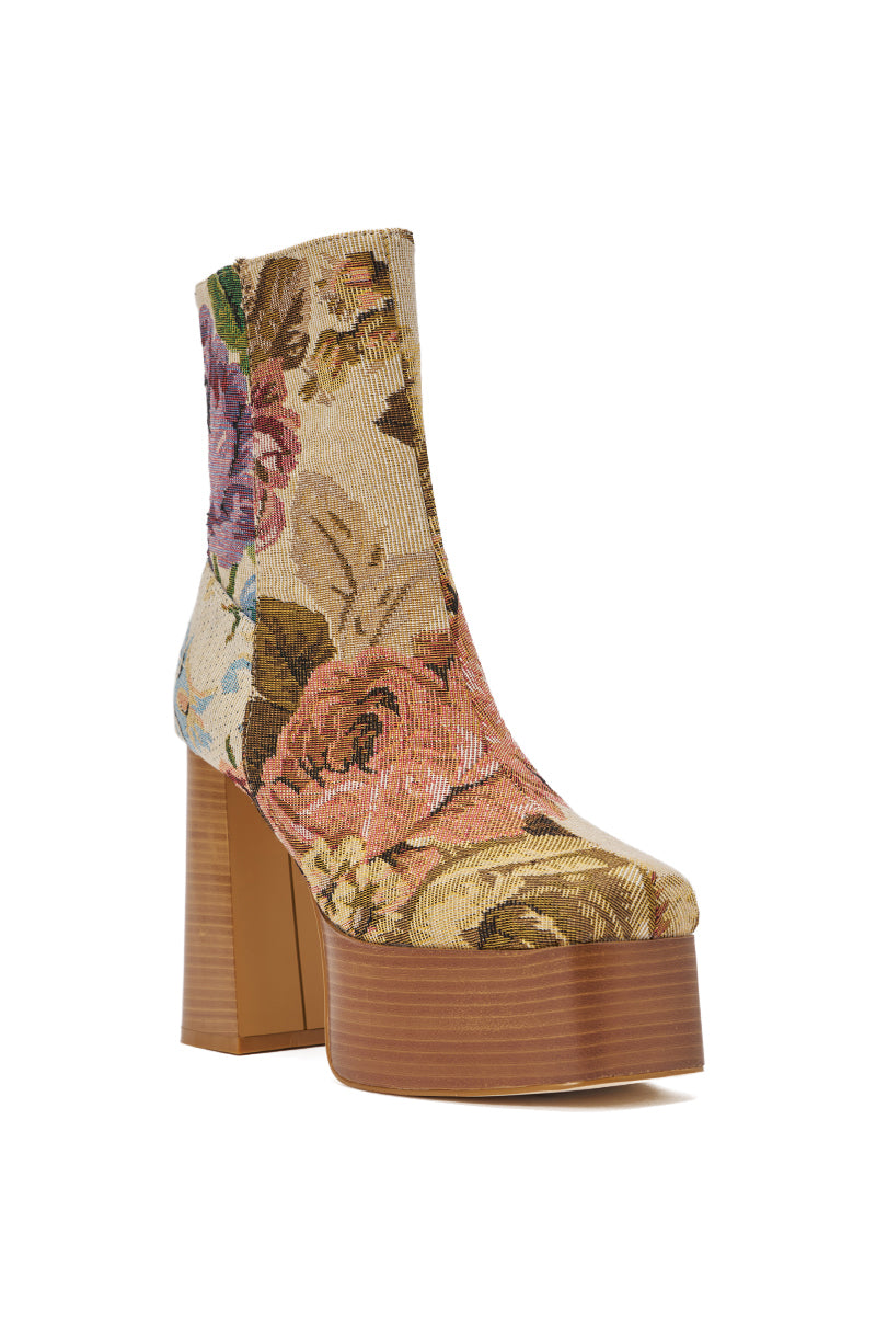 Stand out in the AZALEA WANG ZILPAH FLORAL BROCADE BOOTIE, a high-heeled platform boot with a chunky block heel, wooden sole, and vintage-style floral tapestry in pink, yellow, and green tones. 4