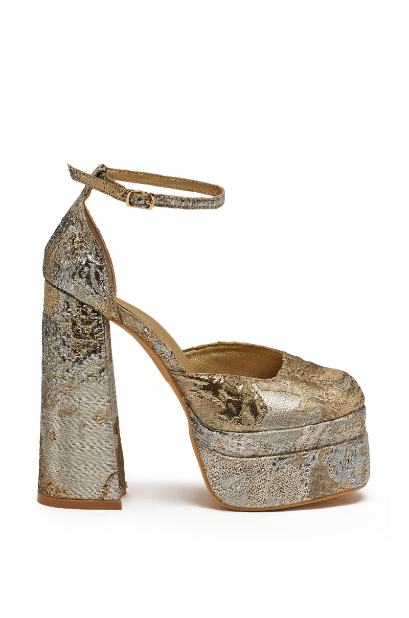 The AZALEA WANG ZIPPHORA GOLD MULTI BROCADE PLATFORM PUMP features a silver brocade upper with a textured metallic floral design, a thick gold block heel, platform sole, and an ankle strap. 3