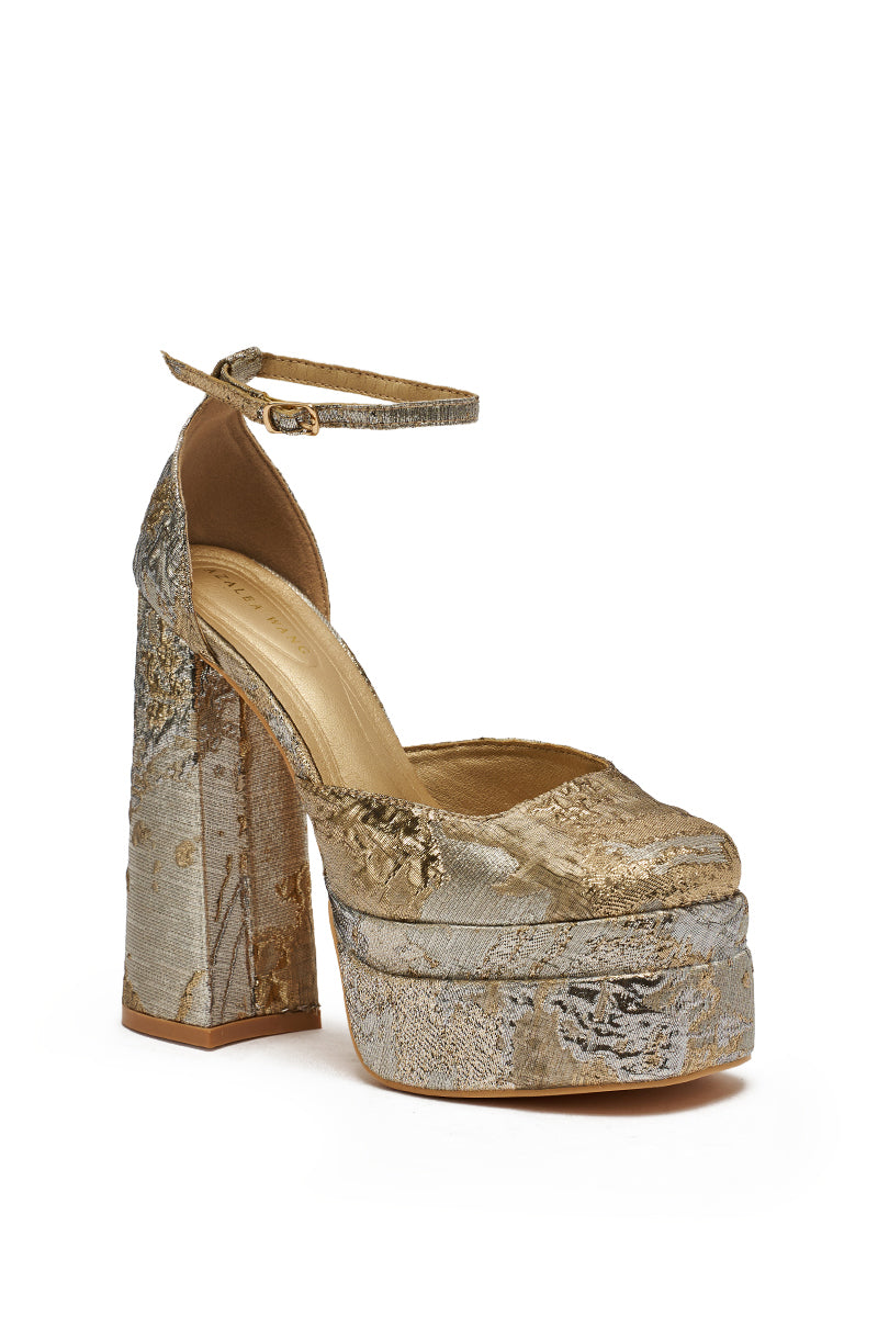 The AZALEA WANG ZIPPHORA GOLD MULTI BROCADE PLATFORM PUMP features a gold brocade design with a chunky block heel, ankle strap, and metallic embroidered patterns. 4