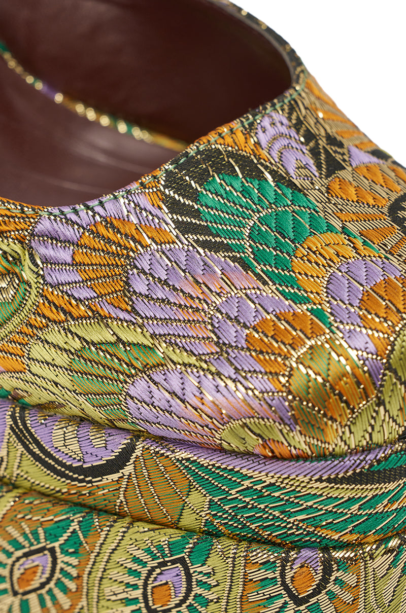 A close-up of the AZALEA WANG ZIPPHORA GREEN MULTI BROCADE PLATFORM PUMP shows a colorful, intricate gold, green, orange, purple, and black patterned fabric with a richly textured surface. 11
