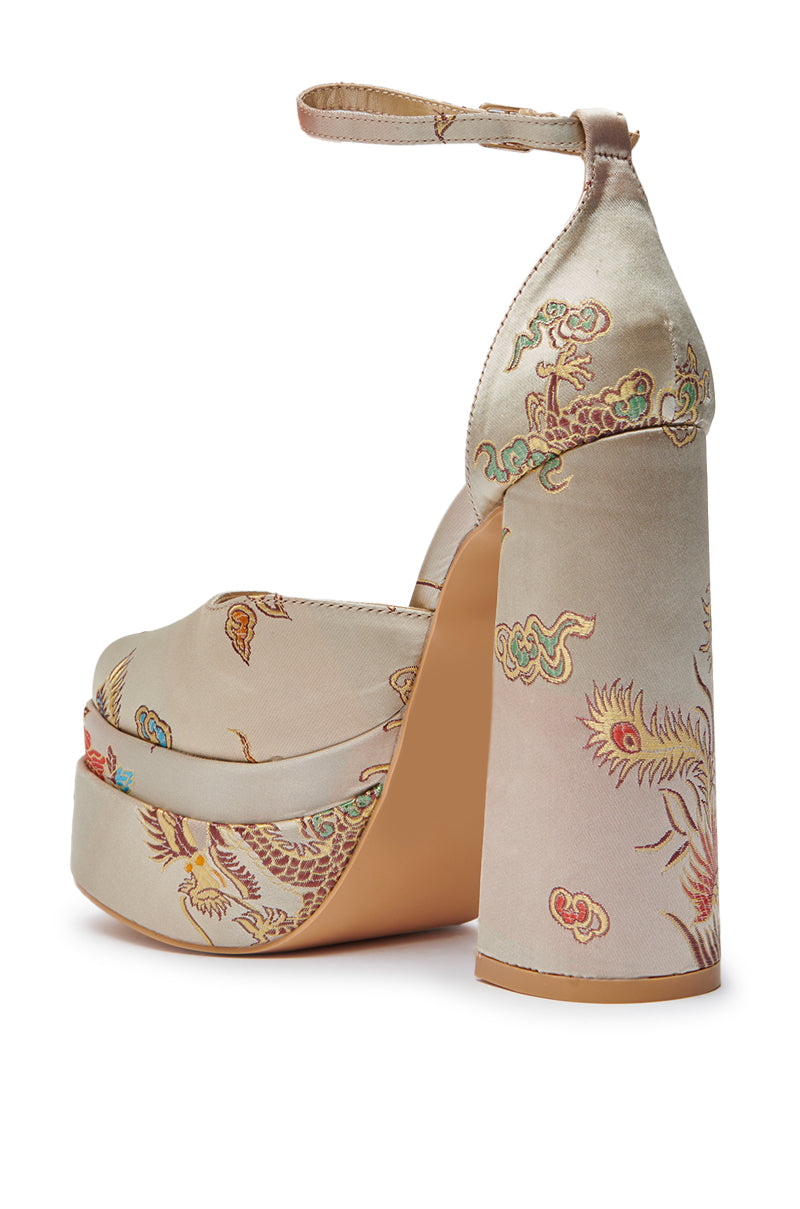 The AZALEA WANG ZIPPORAH NEW BROCADE MARY JANE PLATFORM PUMP is a high-heeled, light beige satin Mary Jane with an ankle strap, chunky heel, and intricate colorful dragon and floral patterns. 5
