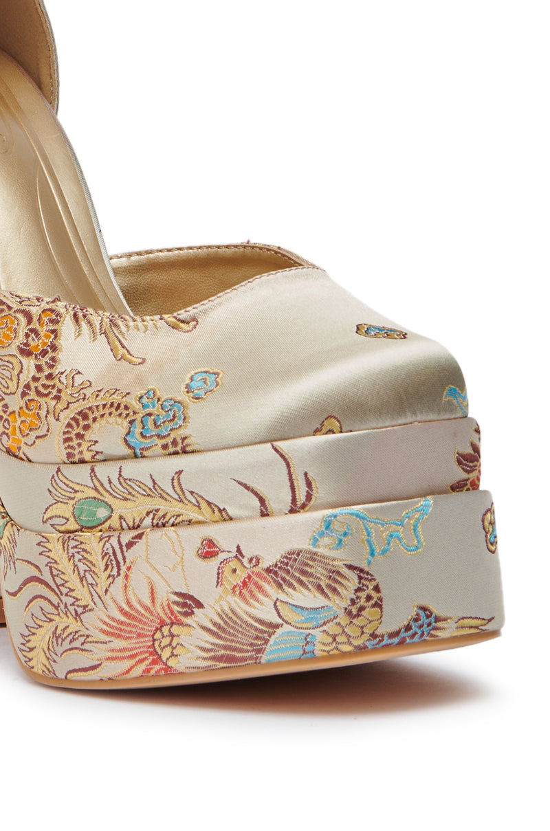 Close-up of the AZALEA WANG ZIPPORAH NEW BROCADE MARY JANE PLATFORM PUMP, featuring a chunky heel and intricate multicolored embroidered floral and animal motifs on cream satin. 6