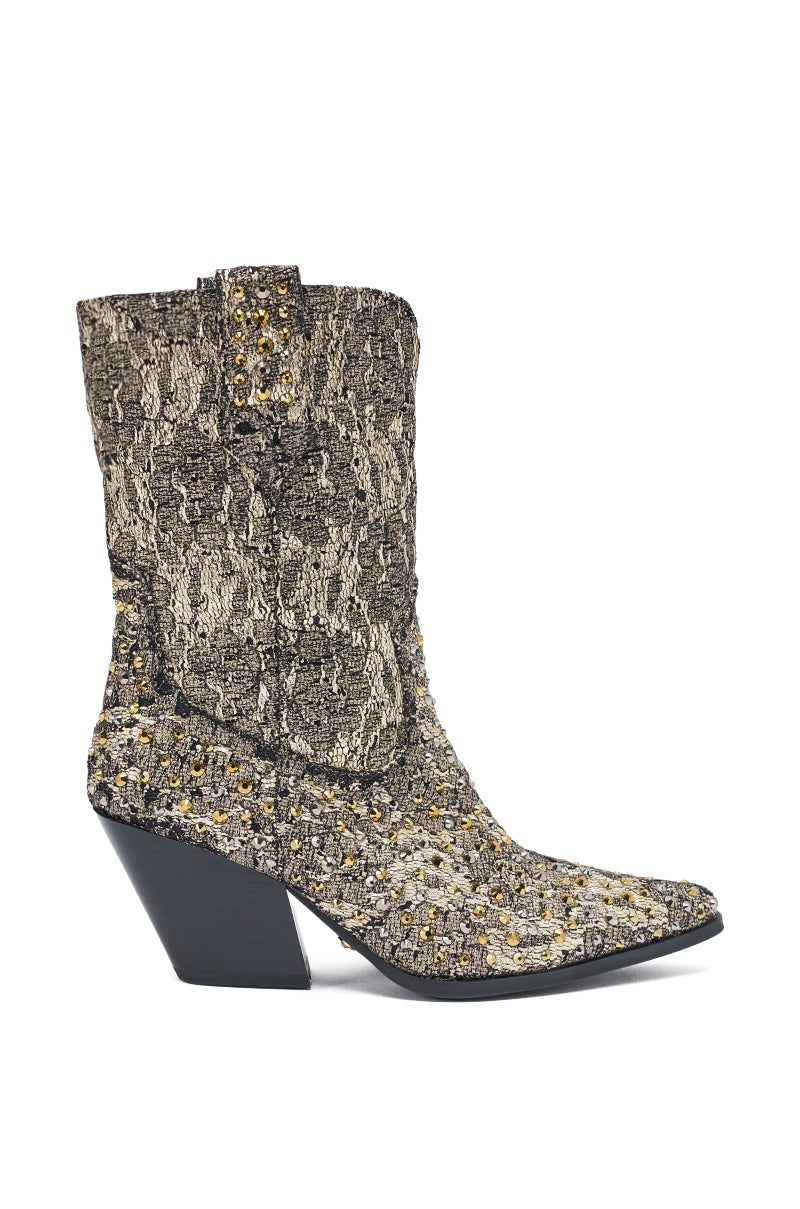 The AZALEA WANG ZIRENNE Gold and Black Brocade Rhinestone Embellished Western Boot features a pointed toe, angled heel, and striking brocade finish adorned with sparkling rhinestones for bold western-inspired style.