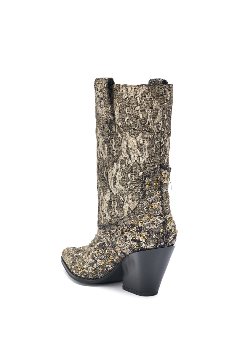 The AZALEA WANG ZIRENNE Gold and Black Brocade Rhinestone Embellished Western Boot is a single mid-calf, pointed-toe boot with a chunky black heel, textured fabric in neutral tones, and metallic stud accents for added flair.