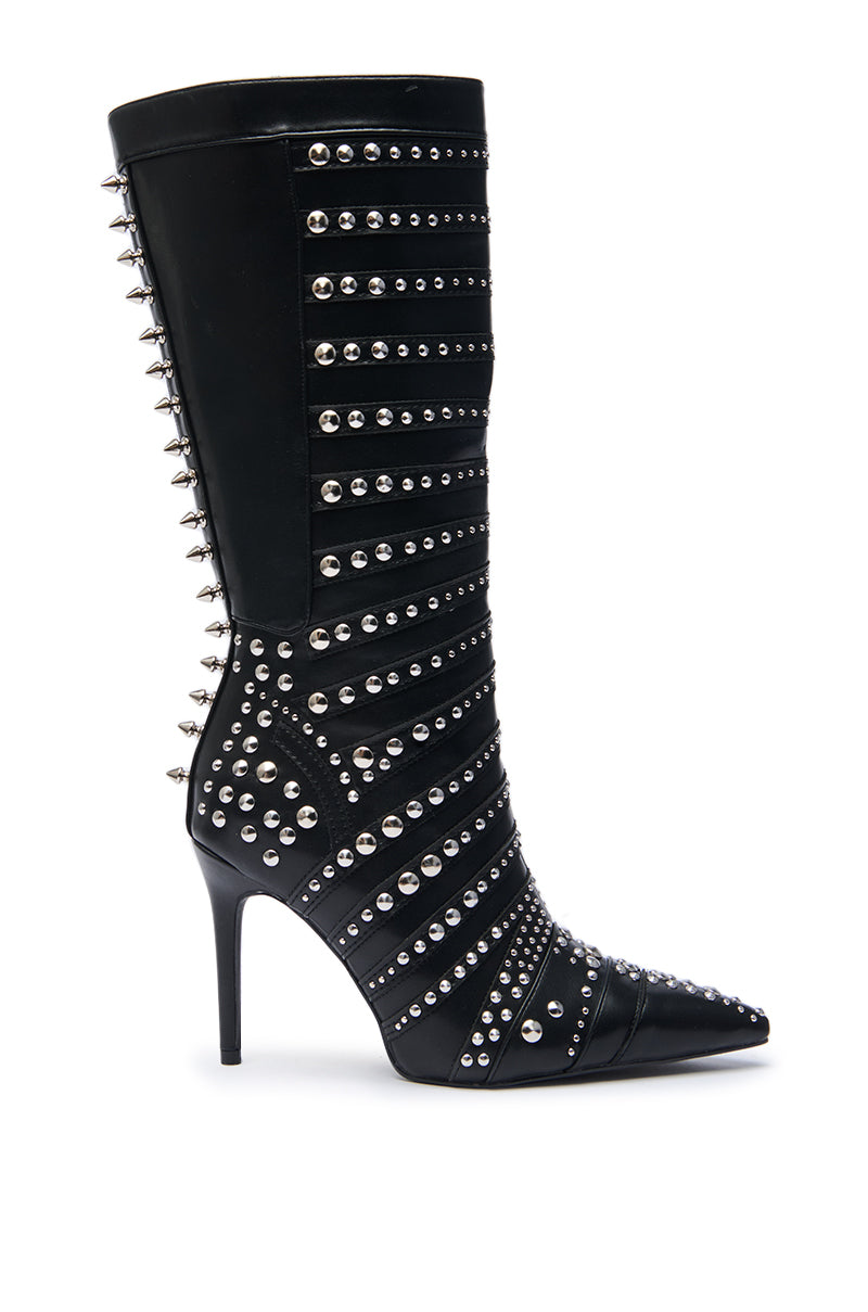 The AZALEA WANG ZOX Black Rhinestone and Studded Black Bootie is a knee-high stiletto with a pointed toe, featuring silver studs and spikes in horizontal and diagonal patterns, plus spikes along the back seam and heel.