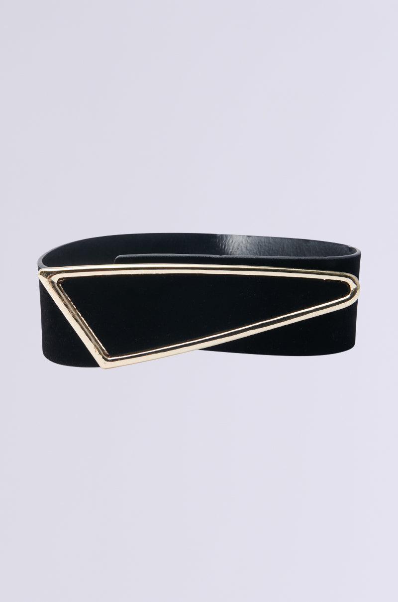 The GLORY ASYMMETRICAL BELT has a black faux leather design with an asymmetrical triangular gold buckle set against a plain gray background. 0