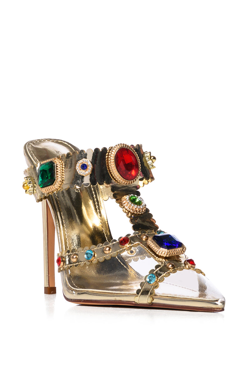 The AZALEA WANG ZYA Multi Gold Embellished PVC Pump is a high-heeled sandal with a metallic gold finish, featuring multiple straps adorned with large red, green, and blue gems. Its pointed toe and stiletto heel add elegance to the ornate design of this exquisite shoe.