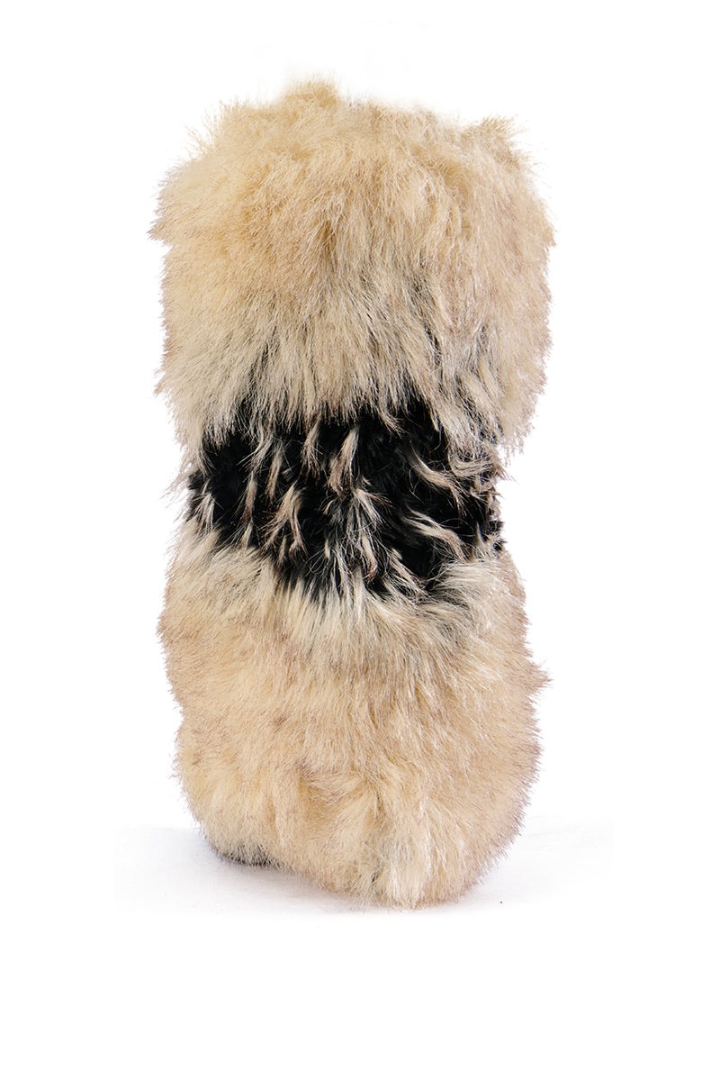 The AZALEA WANG EKKO MULTI FUR STILETTO BOOT is a tall, cylindrical stiletto wrapped in fluffy faux fur of beige and brown tones, featuring a dark fur band at its center, displayed on a plain white background.