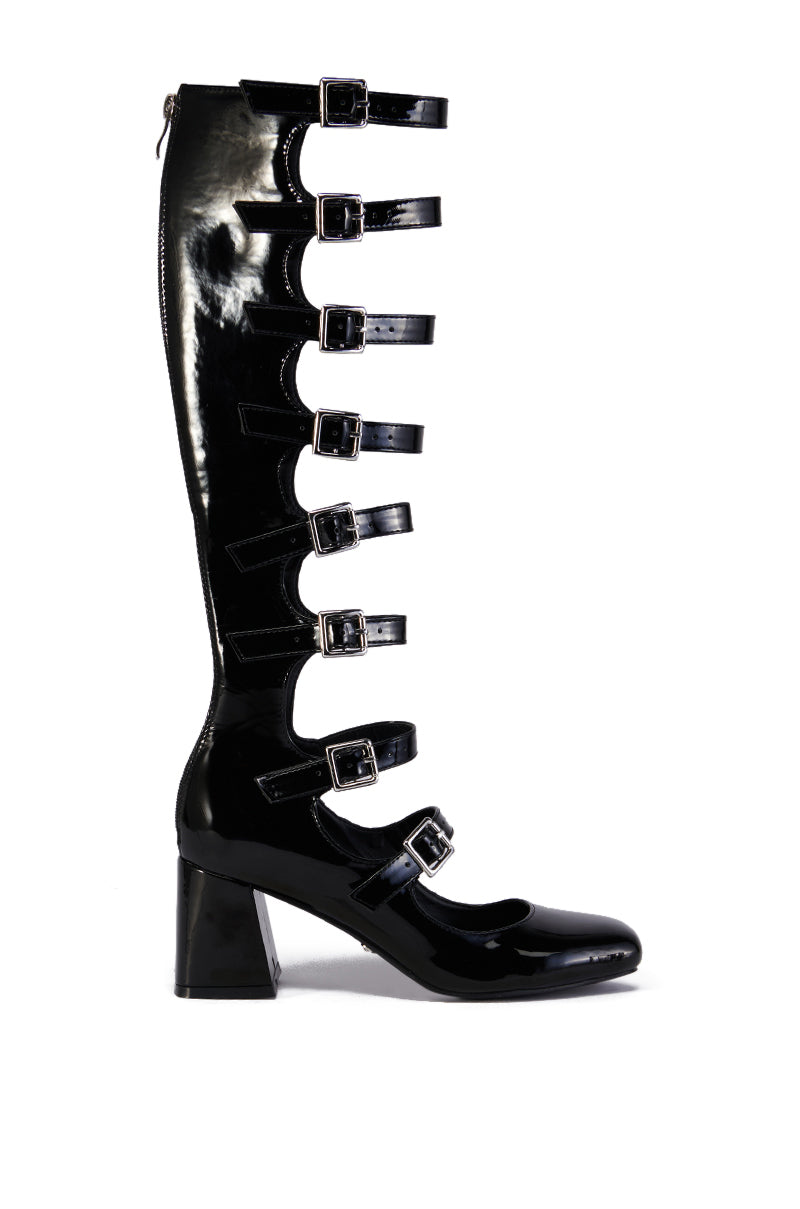 The AZALEA WANG LAIMA BLACK BOOT is a knee-high, glossy faux leather boot featuring a chunky heel and six horizontal buckle straps across the front.