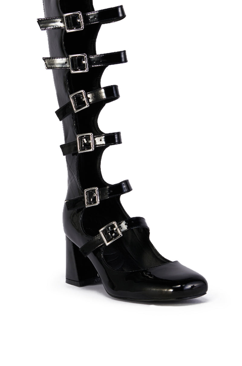 The AZALEA WANG LAIMA BLACK BOOT is a shiny knee-high patent boot with multiple thick straps and silver buckles up the ankle and calf, featuring a chunky heel and glossy finish, shown on a white background.