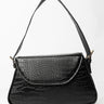 The BETTA CROC EVERYDAY PURSE is a black shoulder bag featuring a textured, faux crocodile leather surface. This rectangular-shaped bag with rounded edges comes with a flap closure on the front. The single strap is affixed to the sides using metal hardware.