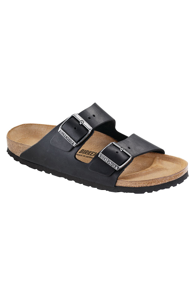 A single SEXY CASUAL FLAT black sandal with two adjustable straps featuring metallic buckles. The sandal has a cork footbed and a black sole. It is angled slightly to display both the top and side views.