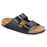 A single SEXY CASUAL FLAT black sandal with two adjustable straps featuring metallic buckles. The sandal has a cork footbed and a black sole. It is angled slightly to display both the top and side views.