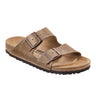 The BIRKENSTOCK ARIZONA TOBACCO OIL LEATHER sandal features a single tan-colored design with two adjustable straps adorned with dark brown buckles. It includes a cork footbed and a textured black sole, prominently displaying the "Birkenstock" brand on the footbed.