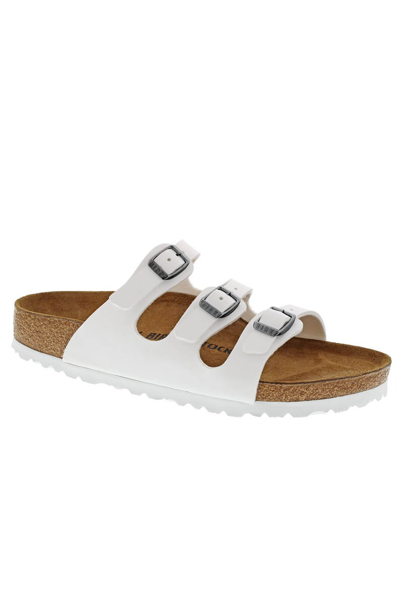 The BIRKENSTOCK FLORIDA BF WHITE sandal features a contoured cork footbed and a white rubber sole. It boasts three adjustable white straps across the top, each equipped with a silver buckle for customized comfort.