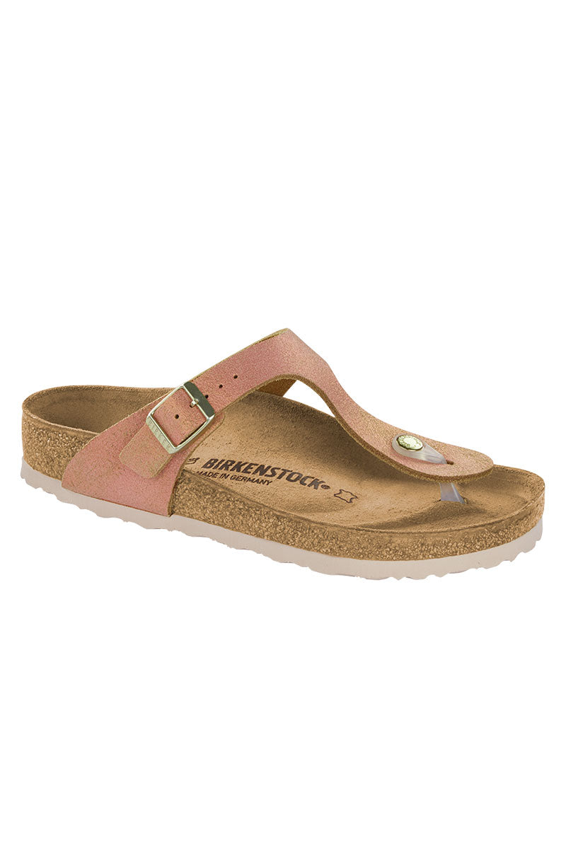 A single SEXY CASUAL FLAT sandal by Birkenstock, featuring a brown cork sole and a peach-colored suede thong strap with a metallic buckle. The footbed has "BIRKENSTOCK" printed on it. The sandal is displayed against a plain white background.