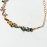 The COLOR RUSH LINK BRACELET features a delicate gold chain adorned with gemstone charms in various shapes and colors, including rectangular and square cuts in hues of blue, green, yellow, and pink. It is secured with a lobster clasp and has adjustable links for a perfect fit.