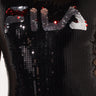 Close-up of the SEXY GRAPHIC DRESSY BODYSUIT by FILA, featuring black sequins that spell out "FILA" across the chest. The reflective sequins change color depending on the angle of light.