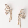 Meet the FLUTTER EARRING, a pair of elegant, butterfly-shaped earrings in a radiant golden hue, embellished with small, sparkling crystals. Their intricate design showcases delicate wings and dangling strands that exude luxury and sophistication. The earrings are beautifully displayed against a plain, light background.