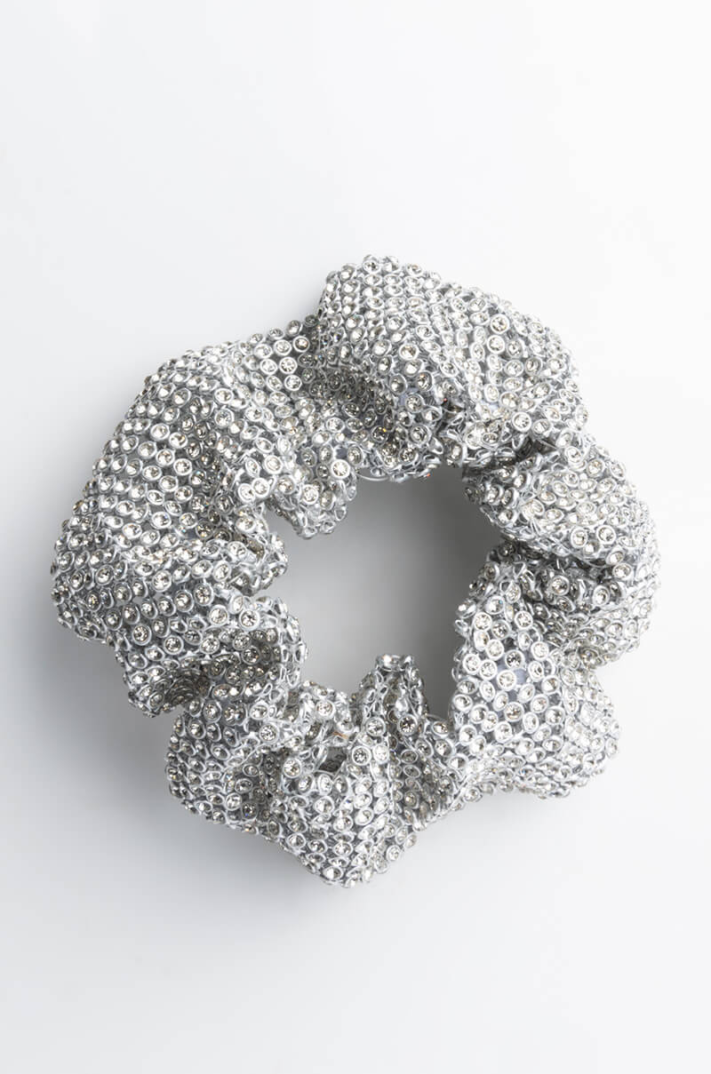 A dazzling FUNKY TOWN RHINESTONE SCRUNCHIE, adorned with shimmering sequins in silver and arranged in a circular shape, is displayed against a plain white background.