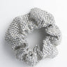 A dazzling FUNKY TOWN RHINESTONE SCRUNCHIE, adorned with shimmering sequins in silver and arranged in a circular shape, is displayed against a plain white background.