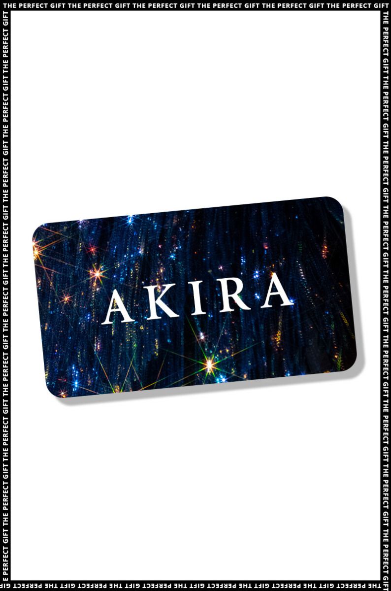 Displayed against a backdrop of blue and white sparkling lights, the AKIRA Gift Card features rounded corners and is presented at a slight angle. Its border displays the repeated text "THE PERFECT GIFT." Redeemable online for a seamless experience, this card embodies the signature style of the AKIRA brand.
