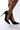 Side View Here To Stay Stiletto Pointed Toe Pump in Black Patent