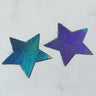 Product LP-STR-NS features two star-shaped patches with a holographic, scale-like texture that transitions in color from green to blue to purple, set against a light marble-like background.