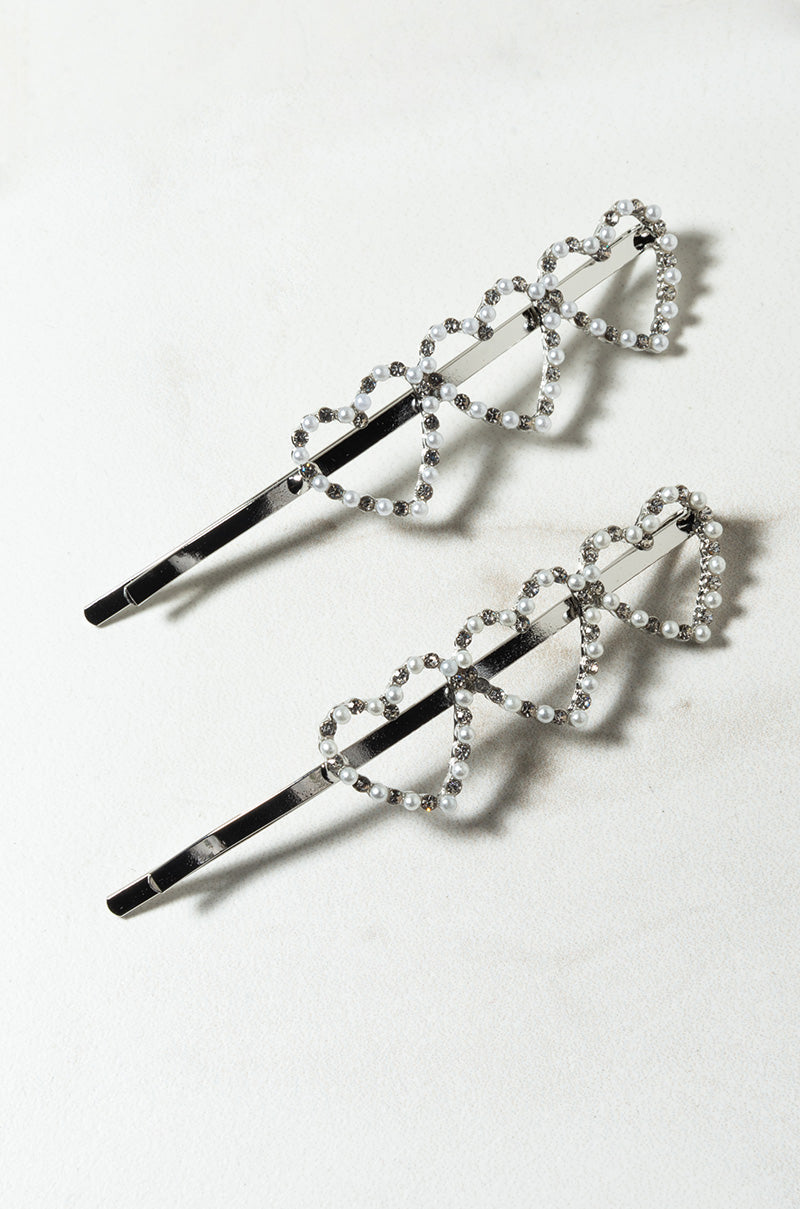 A pair of SEXY HEADBAND HAT decorative hairpins are displayed on a plain surface. Each hairpin features three interlocking heart shapes embellished with small, shiny rhinestones, creating an elegant and sparkling design.