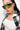 A person with long dark hair wears oversized OCULOS HOLOGRAM AB STONE SUNGLASS, large hoop earrings, a white crop top, and a black-and-white checkered shirt over it. The individual stands against a plain white background.