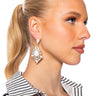 Front View On The Low Embellished Dangle Earrings In White