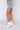 Side View Opposite Direction High Waisted Denim Shorts in Light Blue Denim