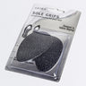 A packaged pair of black sole grips labeled "OUTER SOLE SHOE GRIPS: Extra cushioning for your feet." The packaging mentions that the grips are designed to reduce slipping and can be attached to the bottoms of shoes. The product is displayed against a plain white background.