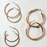 Displayed against a light surface, the "PERFECT PAIR HOOP SET" showcases four pairs of gold-tone hoop earrings. From left to right: a small pair adorned with rhinestones, a larger textured pair, a medium-sized smooth pair, and another small pair featuring a double hoop design.