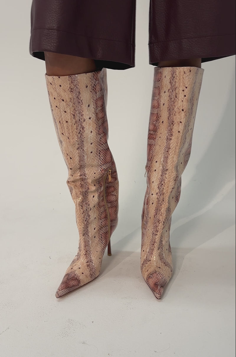Video of woman modeling the AZALEA WANG MADEYE NUDE SNAKE STILETTO BOOTS, creating a stylish and edgy look.