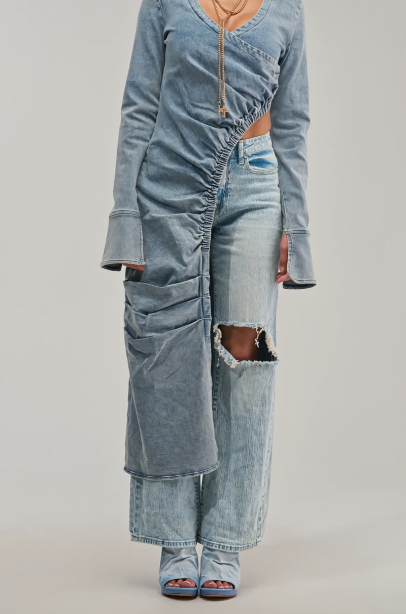 Video of woman modeling the GET MY CLOSE UP LONG DENIM BLOUSE, layered over ripped jeans