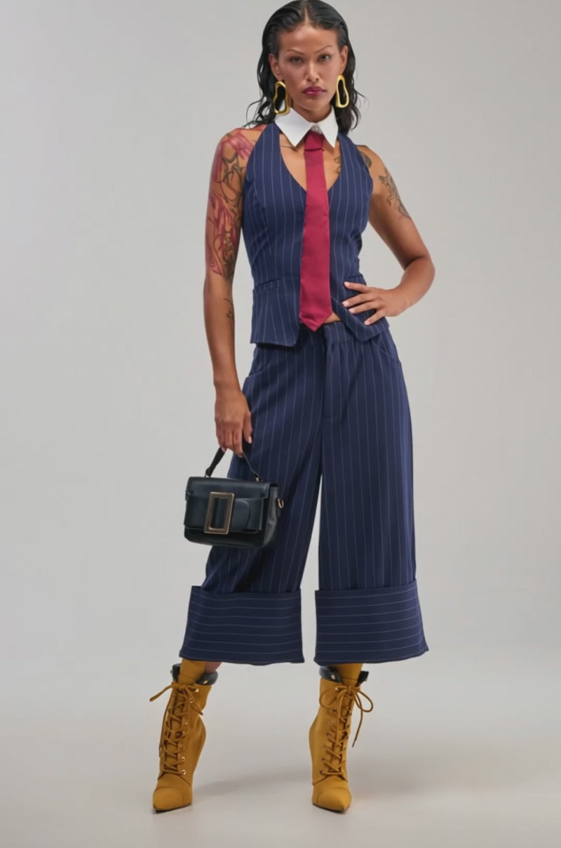 Video of a woman modeling the BIG BANK STRIPED VEST as part of a blue pinstripe suit with wide-leg pants.