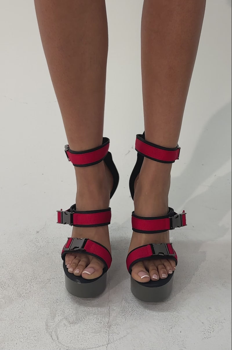 A video of a person wearing AZALEA WANG RAYLYN RED PLATFORM CHUNKY SANDALS.