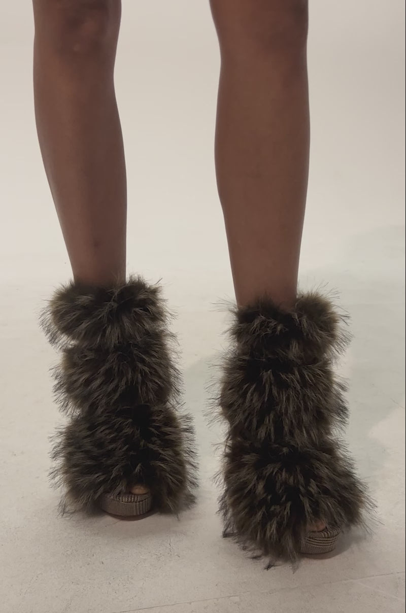 Video of woman modeling the AZALEA WANG SERIOUS Brown Plaid With Fur Open Toe Stiletto Bootie, featuring large fluffy faux fur accents and a platform stiletto heel