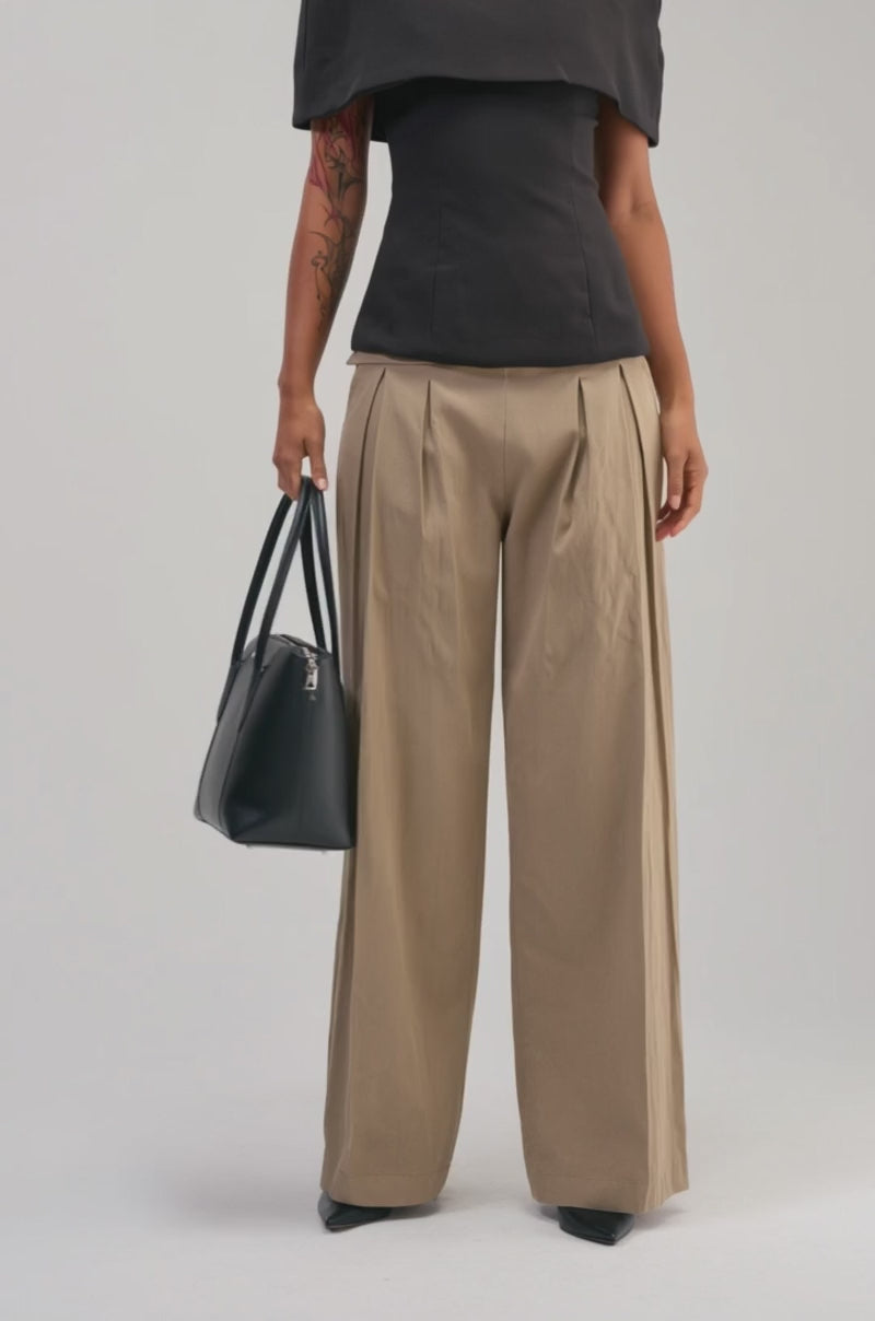 Video of a woman modeling the TIME TO GET SERIOUS BLOUSE, featuring a dramatic black cape-like overlay.