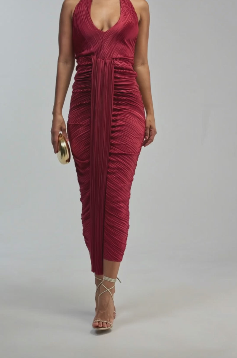 Video of a woman modeling the SARAH SLINKY DRESS IN BURGUNDY—a sleeveless satin dress featuring a plunging neckline and center drape.