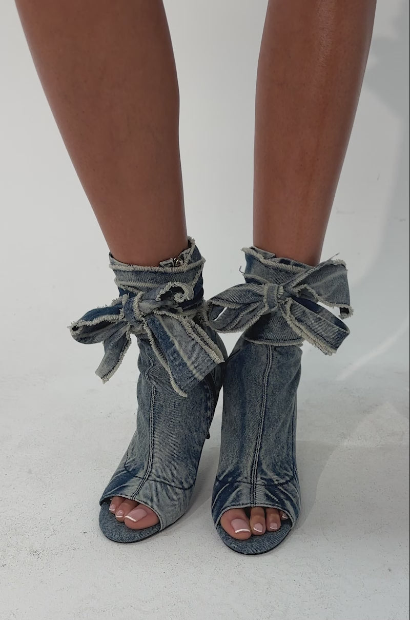 A video of a person wearing the AZALEA WANG KARTER DENIM OPEN TOE BOOTIE.