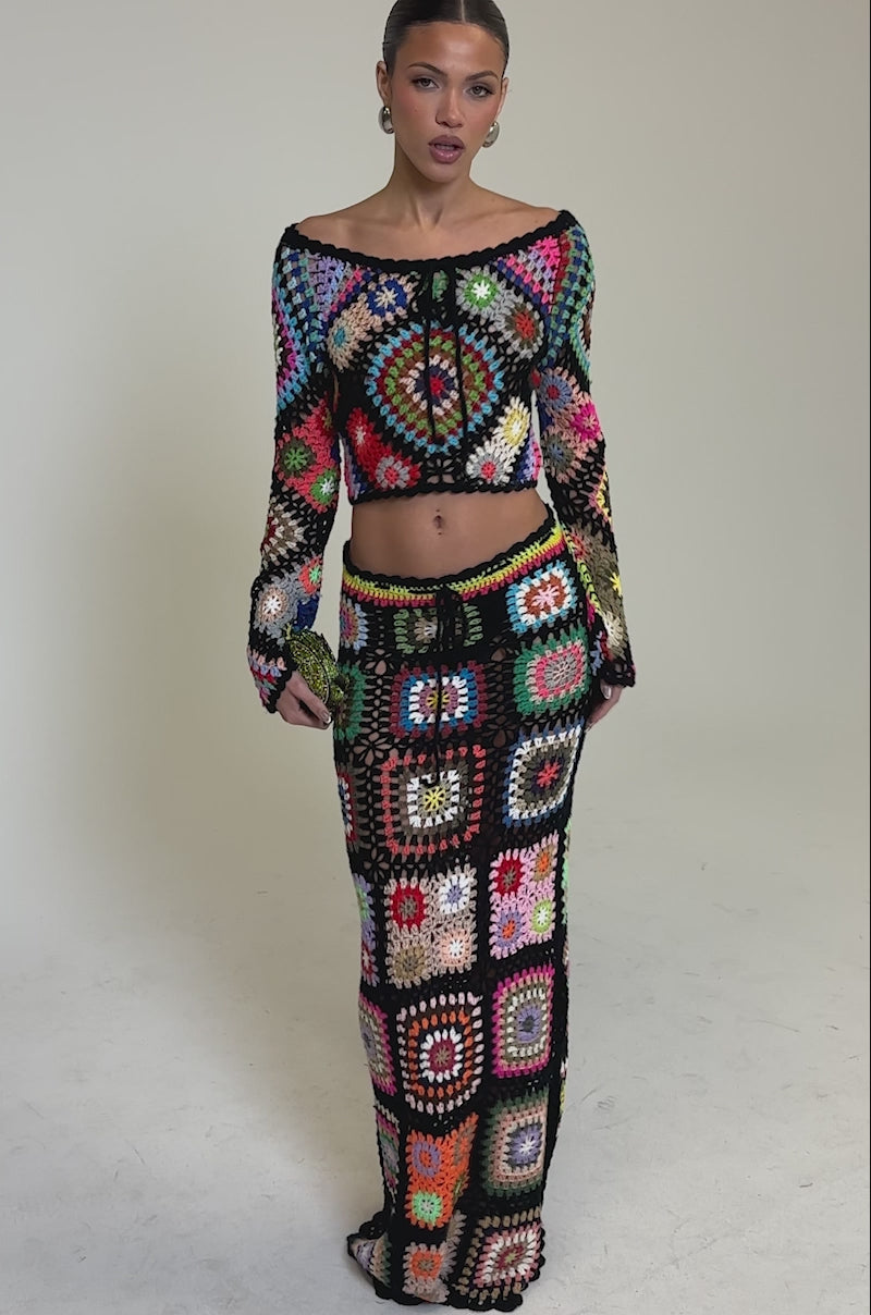 Video of woman modeling the SHINE ON YOU CROCHET TOP and matching skirt, both with vibrant granny-square patchwork, standing against a plain background—perfect for a festival look.