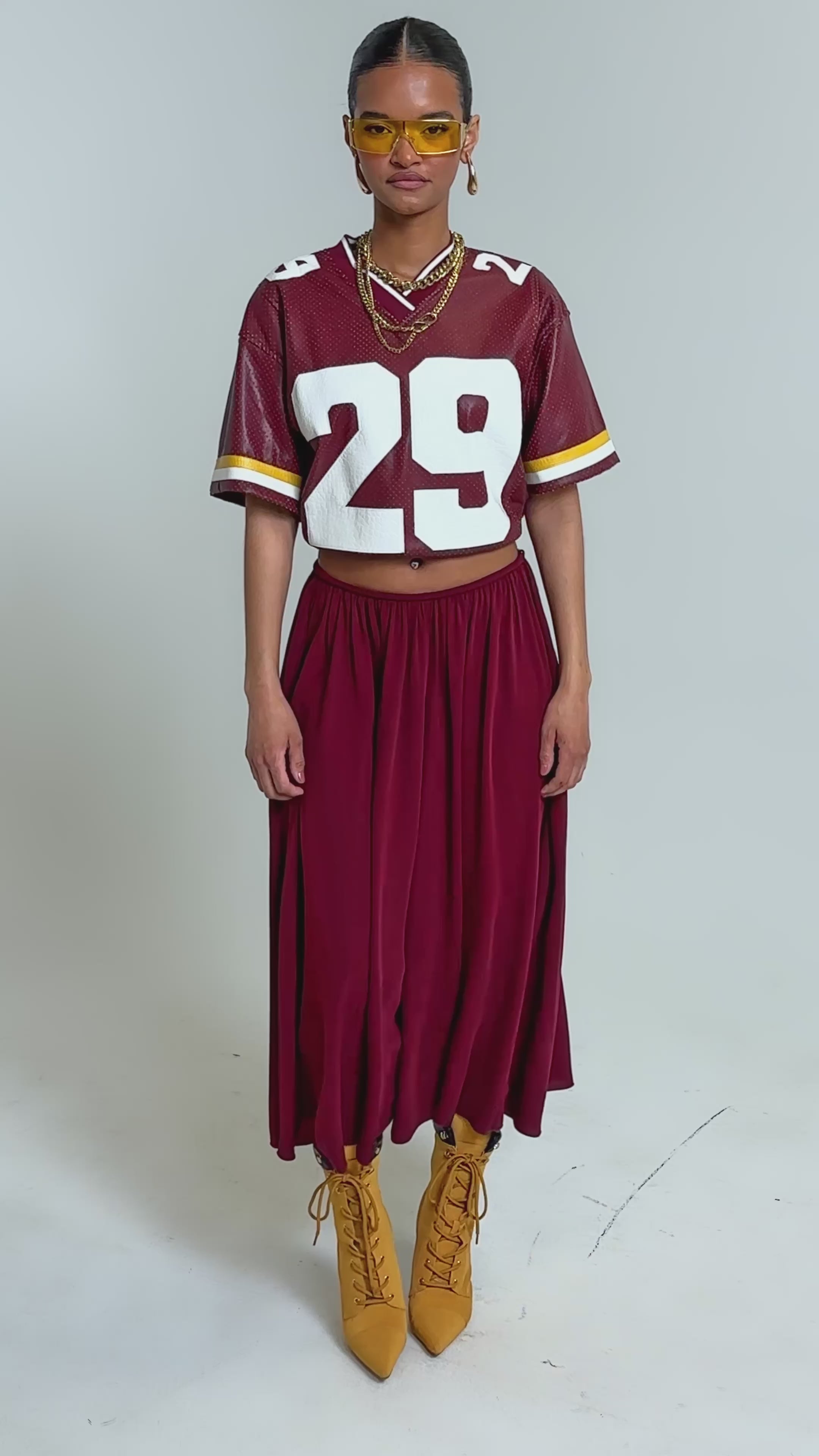 Video of woman modeling the COOL GIRL GAUCHO PANT, and yellow lace-up boots stands against a plain background