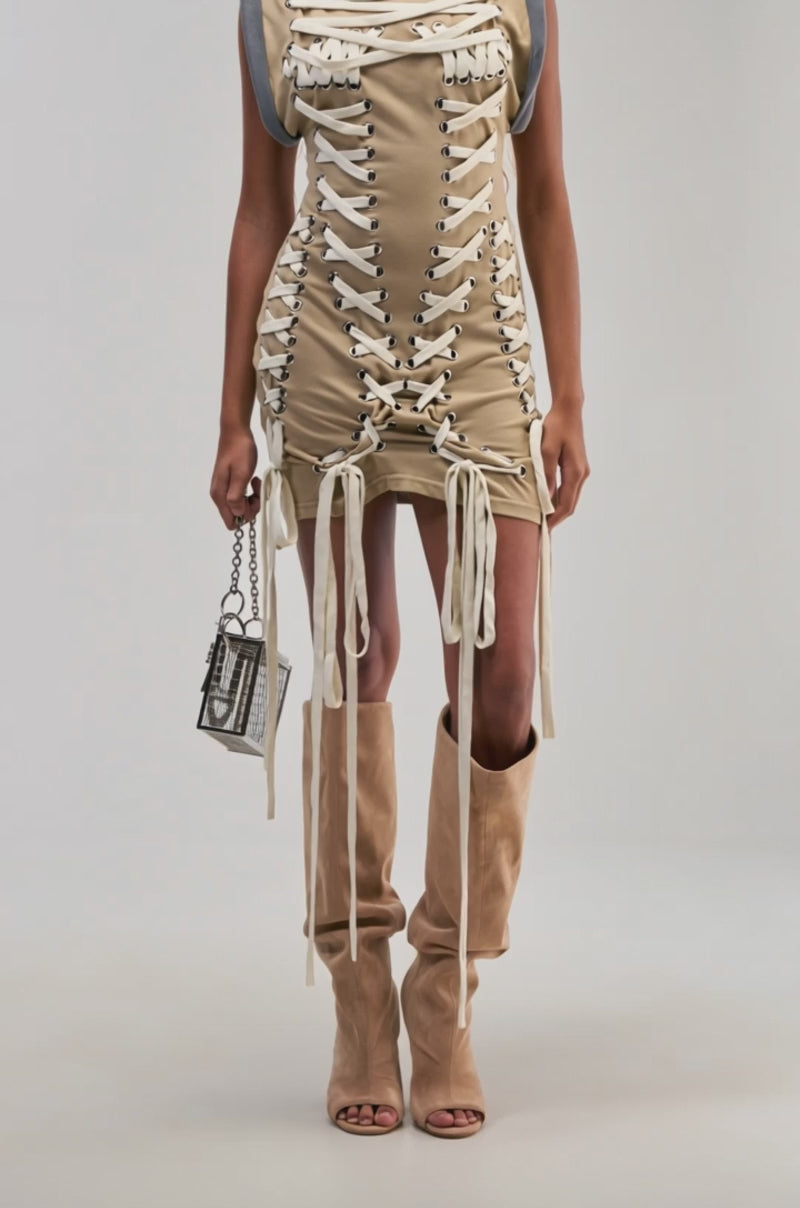 Video of a woman modeling the BANKS LACE UP MOCK NECK KNIT MINI DRESS IN DESERT.