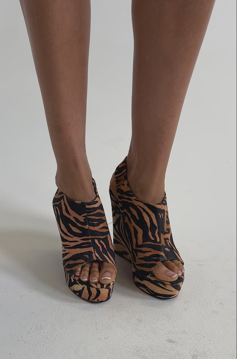 A video of a person wearing AZALEA WANG ARU TIGER WEDGE SANDAL with platform wedge, comfort cushion insole, peep toes, and open heels. 
