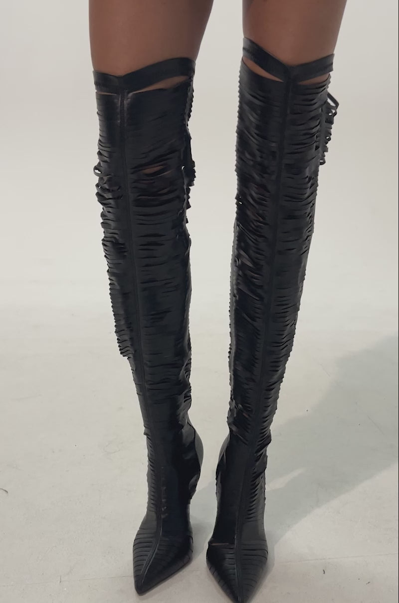 Video of woman modeling the AZALEA WANG BOUDOIR BLACK STRETCH PU OVER THE KNEE CUT OUT BOOTS with pointed toes 