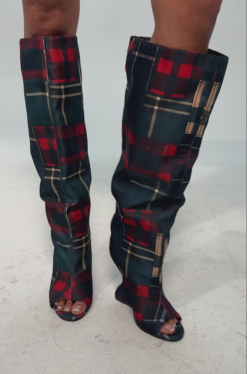 A video of the AZALEA WANG VINCENT PLAID PRINTED OPEN TOE BOOT featuring tall wedge heels and a vibrant patchwork plaid in red, blue, yellow, and green.