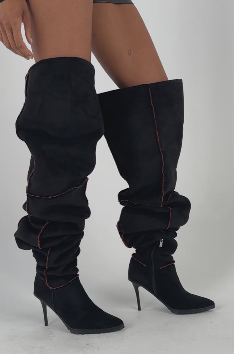 Video of woman modeling the AKIRA GOLD KERRIGAN BLACK MULTI SHERPA STILETTO BOOT, standing against a plain background.